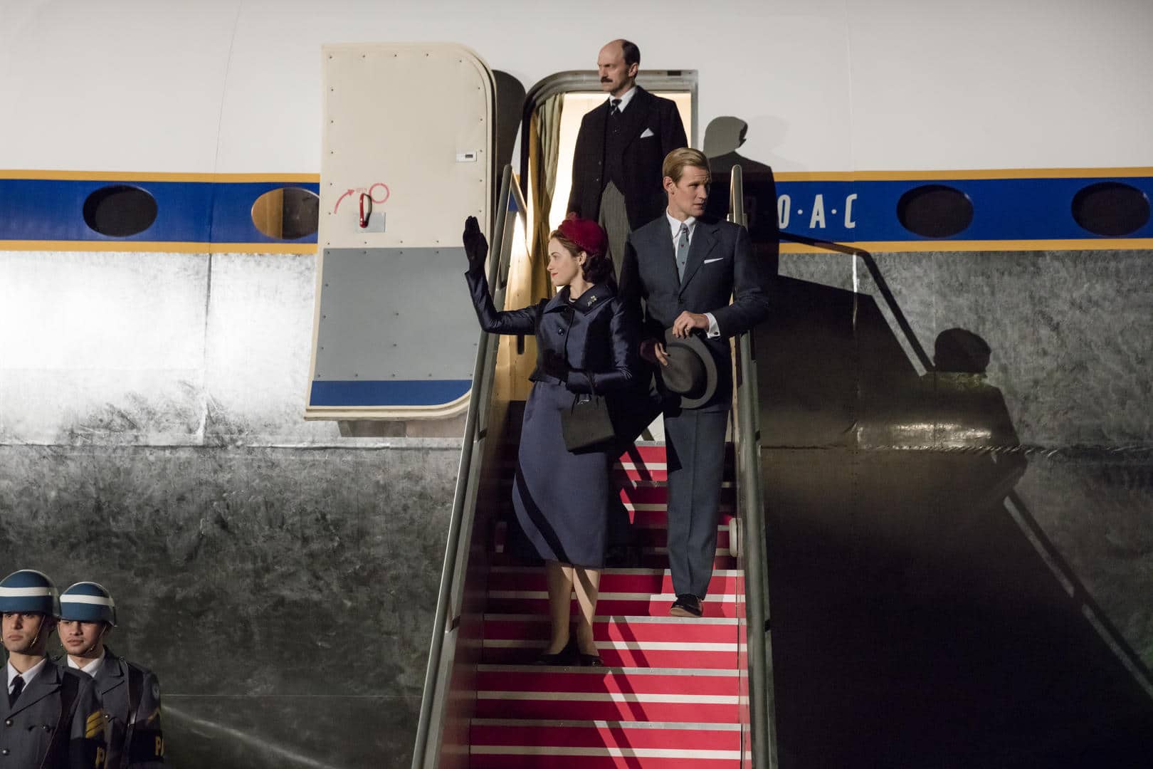 The Crown
(L to R) Elizabeth, Adeane, Philip
Elizabeth and Philip return from the world tour