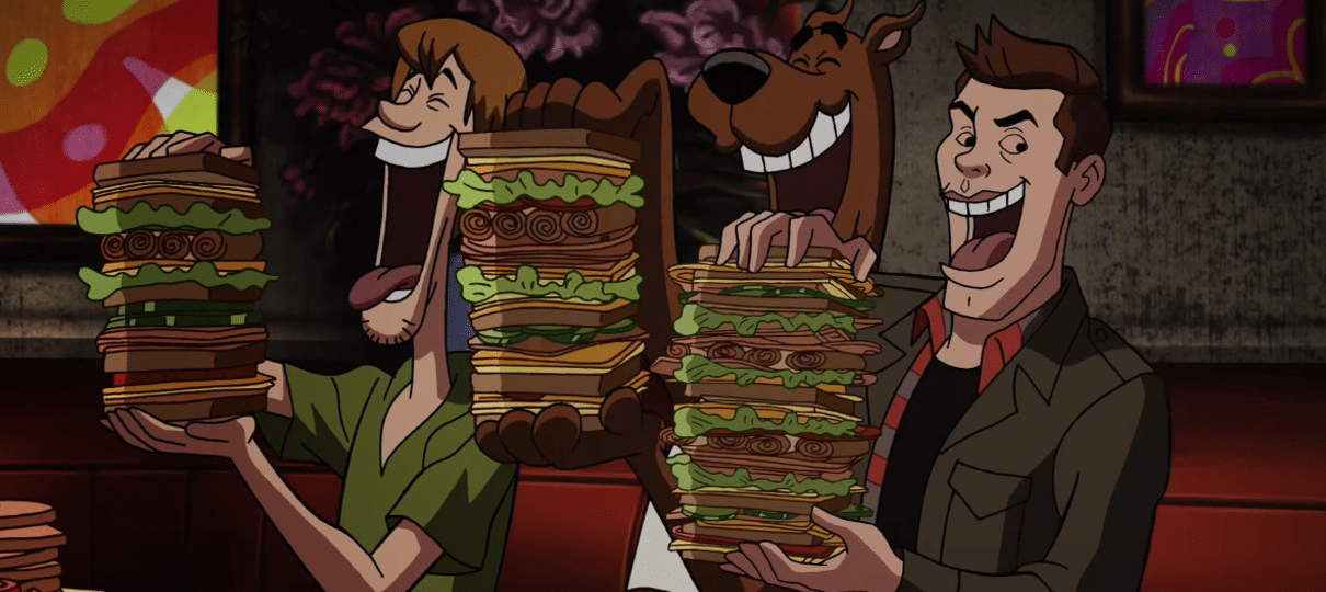 Salsicha, Scooby e Dean se entopem de sandubas em cena do crossover ScoobyNatural