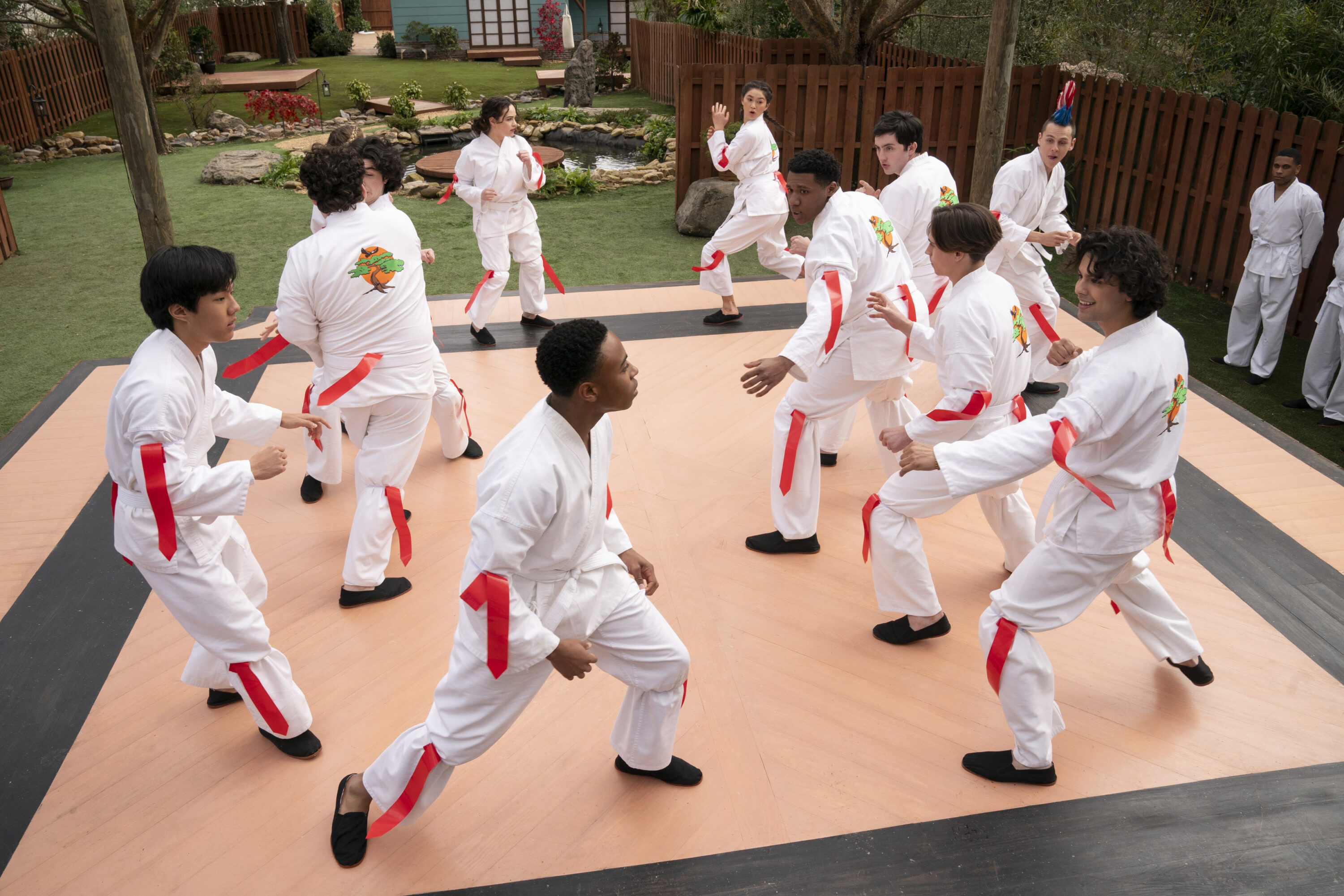 Cobra Kai. (L to R) Nathaniel Oh as Nate, Mary Mouser as Samantha LaRusso, Dallas Dupree Young as Kenny, Oona O’Brien as Devon, Khalil Everage as Chris, Gianni DeCenzo as Demetri, Tanner Buchanan as Robby Keene, Jacob Bertrand as Eli 'Hawk' Moskowitz, Xolo Maridueña as Miguel Diaz in Cobra Kai. Cr. Curtis Bonds Baker/Netflix © 2024
